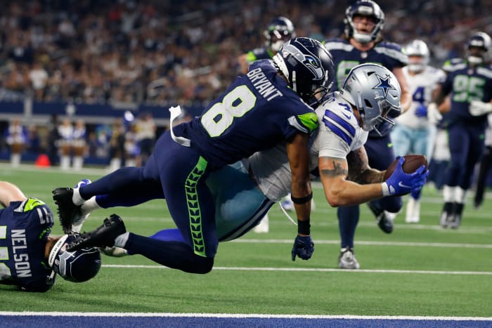 Dallas Cowboys tight end Peyton Hendershot (49) scores a touchdown against Seattle Seahawks cornerback Coby Bryant (8) in the fourth quarter at AT&T Stadium.